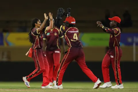 Trinbago Knight Riders players come together to celebrate a wicket