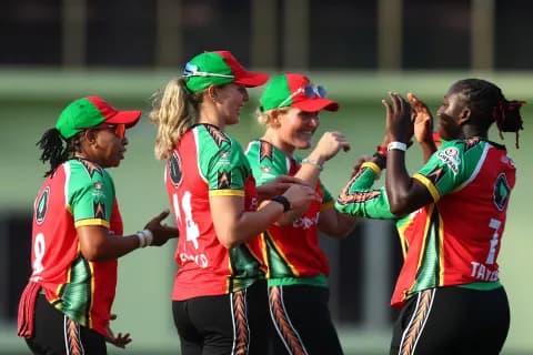 Guyana Amazon Warriors players celebrate together in the field